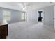 Bright bedroom with neutral walls, a ceiling fan, and large windows overlooking the backyard at 183 Applewood Ln, Acworth, GA 30101