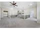 Bright bonus room featuring neutral carpet, ceiling fan, and lots of natural light at 183 Applewood Ln, Acworth, GA 30101