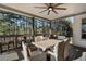 Comfortable covered patio featuring a ceiling fan, dining table, and view of a woodsy backyard at 183 Applewood Ln, Acworth, GA 30101
