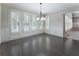 Spacious dining room with many windows, providing lots of natural light and wood flooring at 183 Applewood Ln, Acworth, GA 30101