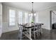 Dining room with updated lighting fixture, wood floors, wainscotting and great natural light at 183 Applewood Ln, Acworth, GA 30101