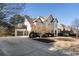 View of neutral painted brick home with 2-car garage and long driveway at 183 Applewood Ln, Acworth, GA 30101