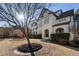 Side view of home featuring painted brick exterior, manicured bushes, and an arched front porch at 183 Applewood Ln, Acworth, GA 30101