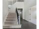 Traditional foyer featuring dark hardwood floors and carpeted stairs with iron balusters at 183 Applewood Ln, Acworth, GA 30101