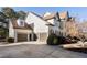 Side view of house with 2-car garage, a long driveway and manicured bushes at 183 Applewood Ln, Acworth, GA 30101