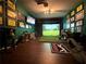 The custom golf simulator room features hardwood floors and plenty of room to play at 183 Applewood Ln, Acworth, GA 30101