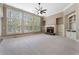 Spacious living room with built-in shelves, brick fireplace, plush carpeting, and natural light at 183 Applewood Ln, Acworth, GA 30101