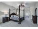 Primary bedroom with ceiling fan, canopy bed, and dark wood dressers on a neutral carpet at 183 Applewood Ln, Acworth, GA 30101