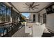 Large deck overlooking the backyard with an outdoor table, chairs, tv and ceiling fan at 183 Applewood Ln, Acworth, GA 30101