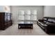 The sitting room features a brown leather couch, wooden coffee table, and a dresser with a lamp at 183 Applewood Ln, Acworth, GA 30101