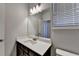 Bathroom vanity featuring granite countertop, dark cabinets, mirror and recessed lighting at 3353 Pearl Ridge Way, Buford, GA 30519