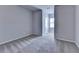 An empty bedroom with neutral walls and carpets, and a bright window view at 3353 Pearl Ridge Way, Buford, GA 30519