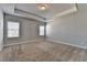 Large carpeted bedroom with recessed lighting, a tray ceiling, and two bright windows at 3353 Pearl Ridge Way, Buford, GA 30519