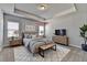 Virtually staged bedroom with tray ceiling, two windows and ensuite furniture at 3353 Pearl Ridge Way, Buford, GA 30519