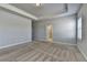 Large carpeted bedroom featuring tray ceiling and natural light, with doorway to bath at 3353 Pearl Ridge Way, Buford, GA 30519