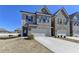 New townhome showing brick facade, a two car garage, and manicured front yard at 3353 Pearl Ridge Way, Buford, GA 30519