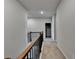 Upstairs hallway featuring neutral paint, carpet and railing to overlook downstairs foyer at 3353 Pearl Ridge Way, Buford, GA 30519