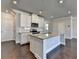 Well-equipped kitchen with stainless appliances, granite counters, a kitchen island, and hardwood flooring at 3353 Pearl Ridge Way, Buford, GA 30519