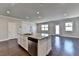 Spacious kitchen island with stainless steel appliances and granite countertops; adjacent living space at 3353 Pearl Ridge Way, Buford, GA 30519