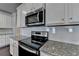 Modern kitchen with stainless steel microwave and range; ample cabinet and countertop space at 3353 Pearl Ridge Way, Buford, GA 30519