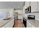 Modern kitchen featuring stainless steel appliances, granite countertops, and ample cabinetry at 3353 Pearl Ridge Way, Buford, GA 30519