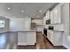 Open-concept kitchen with granite island, stainless appliances, and hardwood floors at 3353 Pearl Ridge Way, Buford, GA 30519