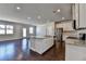 Open-concept kitchen with granite island, stainless appliances, and hardwood floors at 3353 Pearl Ridge Way, Buford, GA 30519