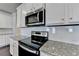 Modern kitchen with stainless steel microwave and range; ample cabinet and countertop space at 3353 Pearl Ridge Way, Buford, GA 30519