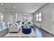 Bright living room featuring modern furnishings, hardwood floors, and an open-concept design with barstool seating at 3353 Pearl Ridge Way, Buford, GA 30519