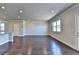 Spacious living area with hardwood floors, recessed lighting, and a view of the modern kitchen layout at 3353 Pearl Ridge Way, Buford, GA 30519