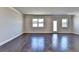 Expansive living area with hardwood floors, white trim, multiple windows, and neutral paint for a modern feel at 3353 Pearl Ridge Way, Buford, GA 30519