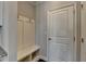Convenient mudroom area with coat hooks, a bench, and storage cubbies near the entrance at 3353 Pearl Ridge Way, Buford, GA 30519