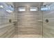 Large glass shower with double shower heads, tiled walls, and tiled floor at 3353 Pearl Ridge Way, Buford, GA 30519