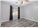 Bright bedroom with gray walls, dark curtains, and wood-look flooring at 115 Hol Mar Trl, Mcdonough, GA 30253