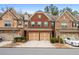 Brick front three-story townhome with two-car garage and landscaped yard at 262 Senna St, Marietta, GA 30064