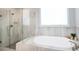 Spa-like bathroom with a large soaking tub and walk-in shower at 768 Marlay Ln, Powder Springs, GA 30127