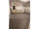 Unfinished basement with gray vinyl flooring and exterior access at 15 Manas Ct, Covington, GA 30016