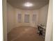 Spacious bedroom with three windows and neutral walls at 15 Manas Ct, Covington, GA 30016