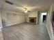 Living room with stone fireplace and wood-look flooring at 15 Manas Ct, Covington, GA 30016