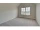 Well-lit bedroom featuring a large window and carpet flooring at 377 Collier Mills Rd, Lawrenceville, GA 30045