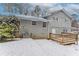 Rear view of house, gray brick, deck, snowy yard at 530 Balfour Dr, Decatur, GA 30032