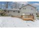 Rear view of house, gray brick, deck, snowy yard at 530 Balfour Dr, Decatur, GA 30032