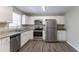 Bright kitchen with white cabinets, granite counters, and stainless steel appliances at 530 Balfour Dr, Decatur, GA 30032