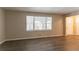 Spacious living room with light walls, wood-look floors, and large windows at 530 Balfour Dr, Decatur, GA 30032