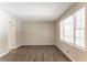 Spacious living room with light walls, wood-look floors, and large windows at 530 Balfour Dr, Decatur, GA 30032