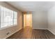 Spacious living room with light walls, wood-look floors, and large windows at 530 Balfour Dr, Decatur, GA 30032