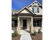 House entrance with stone pillars, a dark door and landscaping at 1609 Tielman Way, Snellville, GA 30078