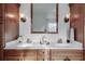 Bathroom with double sink vanity, sconces and decorative wood cabinetry at 3204 Woodrow Ne Way, Atlanta, GA 30319
