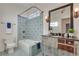 Blue tiled bathroom with mirrored vanity, shower and bathtub at 3204 Woodrow Ne Way, Atlanta, GA 30319