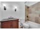 Bathroom features a tiled shower/tub, classic vanity with decorative sconces, and toilet at 3204 Woodrow Ne Way, Atlanta, GA 30319